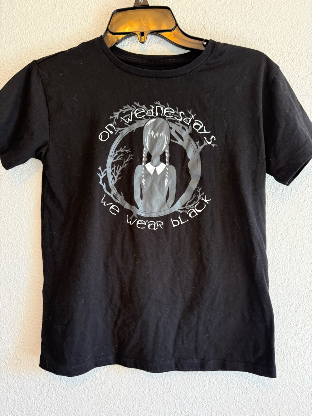 Women’s "On Wednesdays We Wear Black" Graphic Tee large.
